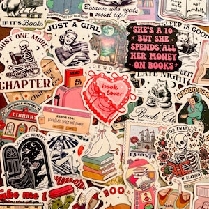 May include: A collection of assorted vinyl stickers featuring book-themed illustrations, including skeletons, cats, and retro characters. Text elements include phrases like 'Just one more chapter', 'She's a 10 but she spends all her money on books', and 'Error 404: Bookshelf space not found'.