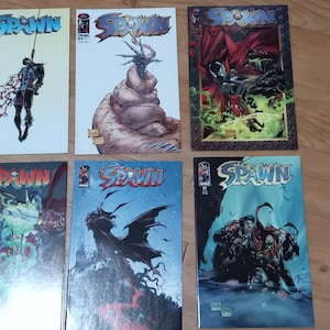 May include: Six comic books featuring the character Spawn. The covers are all different and feature various illustrations of the character in different poses and settings.