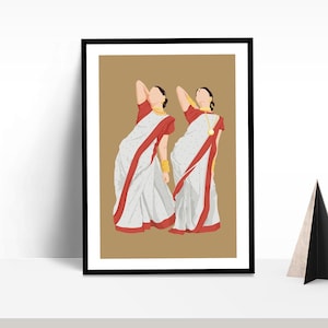 May include: Framed art print featuring two figures in traditional Indian attire. The figures are depicted in white saris with red borders, adorned with gold jewelry. The background is a solid tan color, and the print is framed in black.