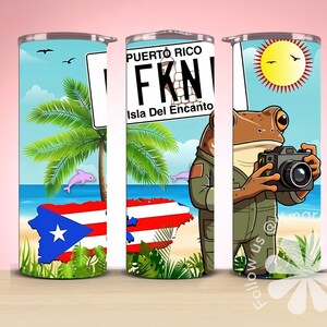 May include: A white tumbler with a colourful design featuring a cartoon frog holding a camera, palm trees, a beach scene, and the text "Puerto Rico FKN Isla Del Encanto".