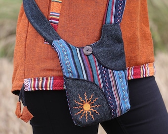 May include: A small, black and blue striped crossbody bag with a sun design. The bag has a flap closure and a long strap.