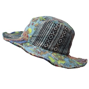 May include: A blue and black patterned bucket hat with a wide brim. The hat has a colorful floral design on the brim and a geometric pattern on the crown.