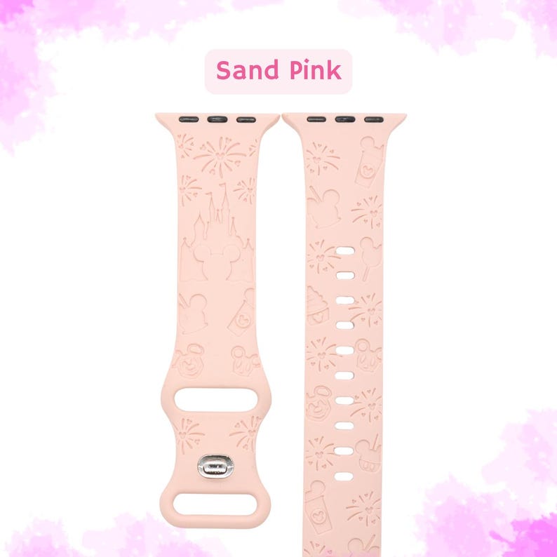 May include: Sand pink Apple Watch band with a Disney theme. The band features a pattern of fireworks, Mickey Mouse, Cinderella's castle, and other Disney icons.
