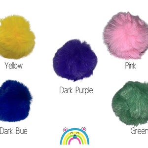May include: Five fluffy pom poms in different colors: yellow, pink, dark purple, dark blue, and green.