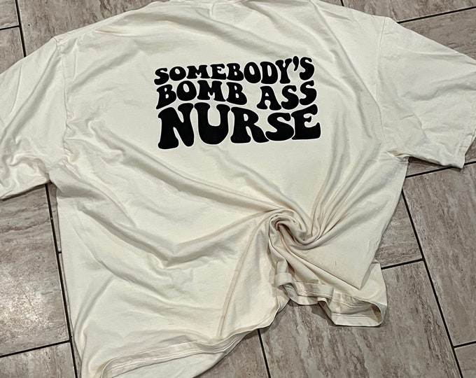 Somebody’s Bomb A** Nurse Shirt - Comfort Colors Cotton Tee