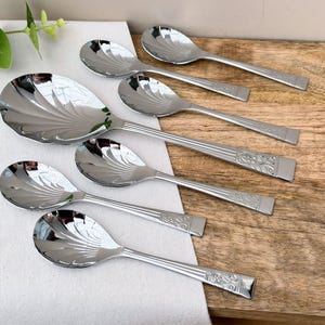 Set med 6 frukt-/trifleskedar i art déco-stil med matchande serveringssked, snäckskålar