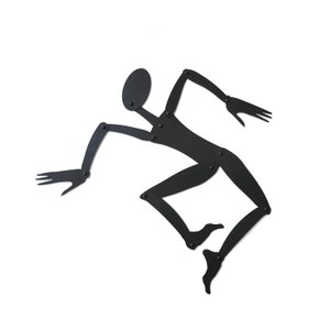 May include: Black metal silhouette of a person in a jumping pose, with articulated limbs and a round head.