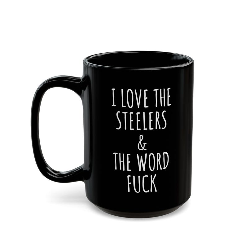 May include: A black ceramic mug with a glossy finish and a curved handle. The front of the mug features white printed text that reads: I LOVE THE STEELERS & THE WORD FUCK. The design is centered on the cylindrical body of the drinking vessel.