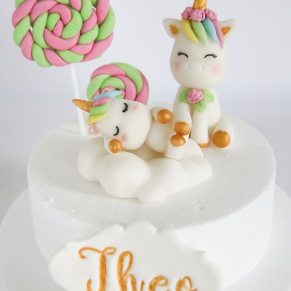 Lindo Baby Unicorn Cake Topper Fondant en Cloud Bed y Unicornio Sonriente con Piruletas y etiqueta de nombre para la fiesta de cumpleaños de bebés y niños