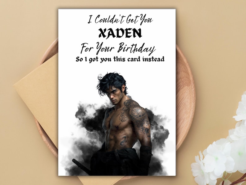 May include: Birthday card with the text "I Couldn't Get You XADEN For Your Birthday So I got you this card instead." The card features a shirtless man with tattoos, surrounded by dark smoke.