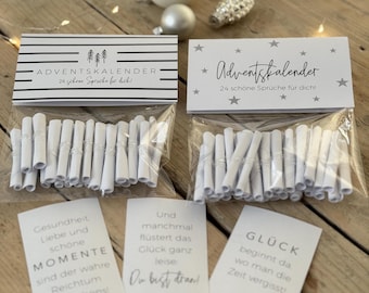 May include: White paper scrolls with black text inside clear plastic bags. The bags are labeled "Advent Calendar" with 24 quotes for the season. The quotes include "Health, love and beautiful moments are the true wealth of life", "And sometimes happiness whispers quietly", and "Happiness begins where you forget time".
