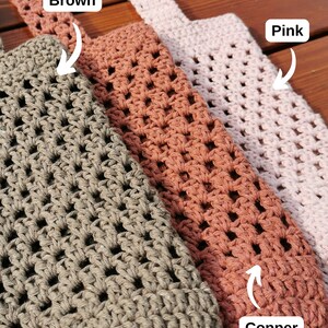 May include: Three crocheted bags in brown, copper, and pink. The bags are made with a square stitch pattern and have a woven strap.