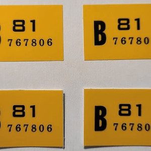 May include: Four yellow rectangular stickers with black text. Each sticker has the letter "B", the number "81", and the number "767806". The stickers are arranged in a 2x2 grid.