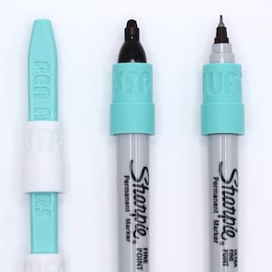 May include: Three turquoise and white pens with the word "Pen" on the turquoise cap of the leftmost pen. The two rightmost pens are Sharpie brand permanent markers with "Fine Point" and "Ultra Fine Point" printed on the barrels.