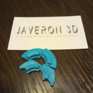 May include: Three teal blue plastic pieces that fit together to form a star shape. The pieces are textured and have a slightly curved shape. The pieces are from JAVERON 3D CUSTOM PRINTING AND DESIGN.