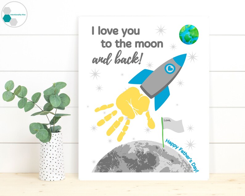 May include: A printable Father's Day card featuring a handprint rocket flying to the moon. The card reads "I love you to the moon and back!" and "Happy Father's Day!"
