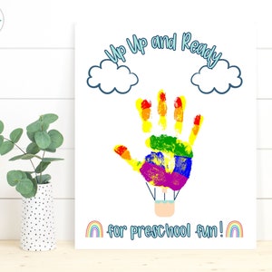 May include: A printable art print with a rainbow handprint hot air balloon design. The text reads "Up Up and Ready for Preschool Fun!" with a rainbow at the bottom.