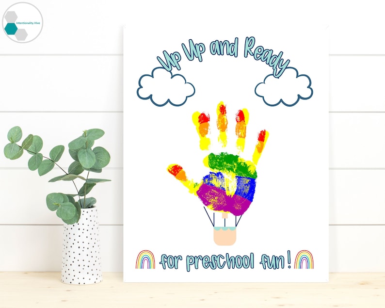 May include: A printable art print with a rainbow handprint hot air balloon design. The text reads "Up Up and Ready for Preschool Fun!" with a rainbow at the bottom.