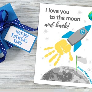 May include: A printable Father's Day card featuring a handprint rocket flying to the moon. The card reads "I love you to the moon and back!" and "Happy Father's Day!"