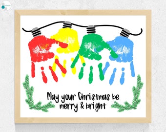 May include: A Christmas-themed handprint art project with the message "May your Christmas be merry & bright". Four handprints are painted in red, yellow, green, and blue, forming a string of Christmas lights.