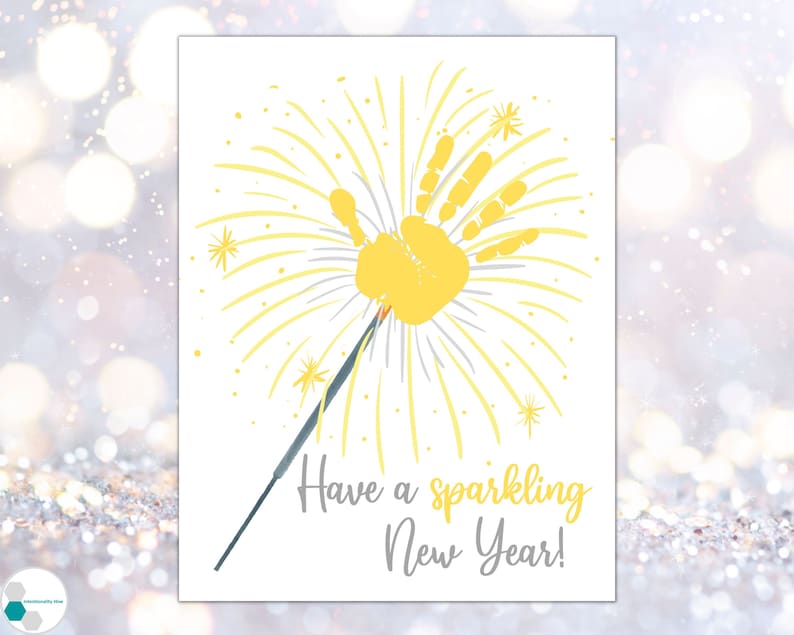 May include: A yellow handprint with gray lines radiating out from it, resembling a firework. The text "Have a sparkling New Year!" is written below the handprint.