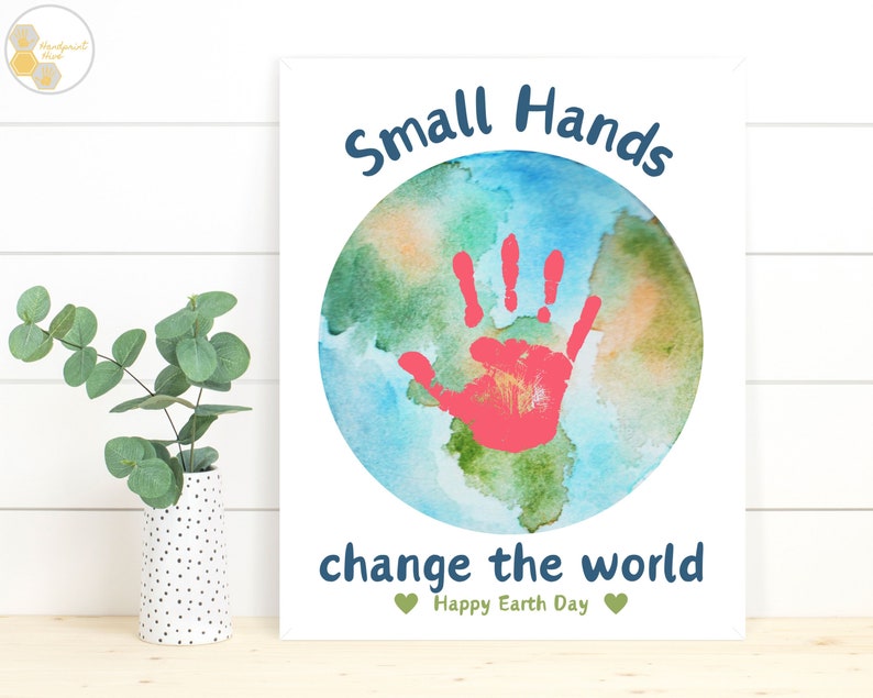 May include: A watercolor painting of the Earth with a red handprint in the center. The text "Small Hands change the world" is written below the Earth, with the words "Happy Earth Day" in smaller font below that.
