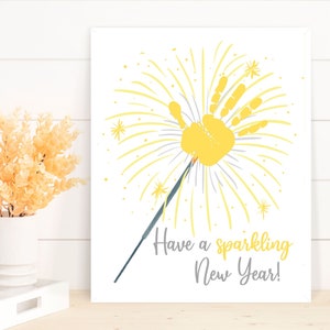 May include: A yellow handprint in the shape of a firework with the text "Have a sparkling New Year!"