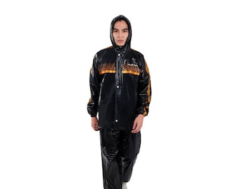May include: A black raincoat with gold accents. The raincoat has a hood and a zipper closure. The model is wearing the raincoat and is standing on a white background.