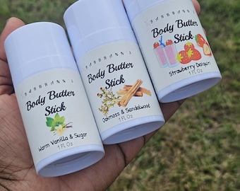 May include: Three white body butter sticks with labels. The labels read "Body Butter Stick" with different scents: Warm Vanilla & Sugar, Oakmoss & Sandalwood, and Strawberry Daiquiri. Each stick is 1 fl oz.