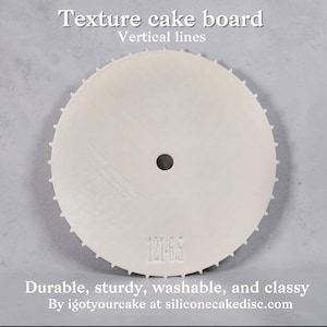 May include: A white, circular texture cake board with vertical lines. It has a central hole and a serrated edge. The text "Texture cake board" and "Vertical lines" are at the top. The text "121-6.5" is printed on the board.