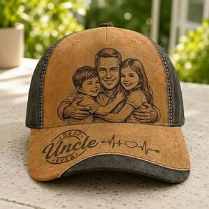 May include: A brown and gray baseball cap featuring a family portrait design. The cap has the words "BEST UNCLE EVER" and a heartbeat graphic on the front. The cap has a curved brim and a mesh back.