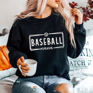 May include: A black sweatshirt with a white graphic that says "Baseball mama" with a baseball icon.