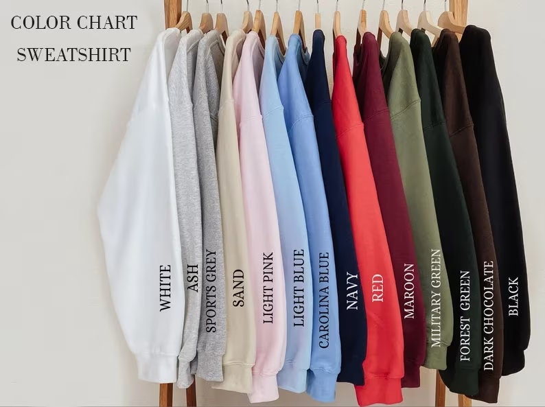 May include: Colour chart of sweatshirts in various colours, including white, ash, sports grey, sand, light pink, light blue, Carolina blue, navy, red, maroon, military green, forest green, dark chocolate, and black.
