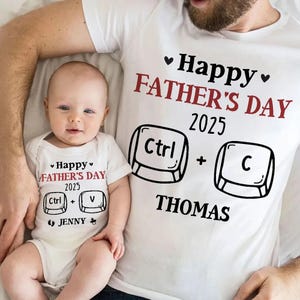 May include: A white t-shirt and baby onesie set with matching "Happy Father's Day 2025" text and keyboard key graphics. The adult shirt says "Ctrl + C THOMAS", while the baby's onesie says "Ctrl + V JENNY".