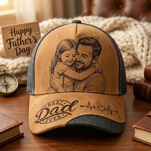 May include: A tan and gray baseball cap featuring an illustration of a father and child embracing. The cap has the words "Best Dad Ever" and a heartbeat graphic. A wooden sign that says "Happy Father's Day" is in the background.