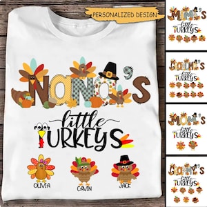 May include: White t-shirt with a Thanksgiving-themed design featuring the text "Nana's little turkeys" with a patchwork style font. The design includes a turkey with a pilgrim hat and a pumpkin. Three smaller turkeys are below the text with the names Olivia, Jack, and Cavin.
