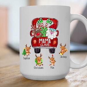 May include: White ceramic mug with a red truck design featuring Santa Claus and reindeer. The truck has the text "MIMI CLAUS" on the back. There are five reindeer with names below them: Sophia, Christian, Mia, Joshep.