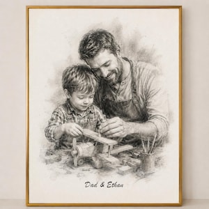May include: A framed pencil sketch depicts a father and son building a wooden airplane. The image is in grayscale, with the text "Dad & Ethan" at the bottom. The frame is gold.