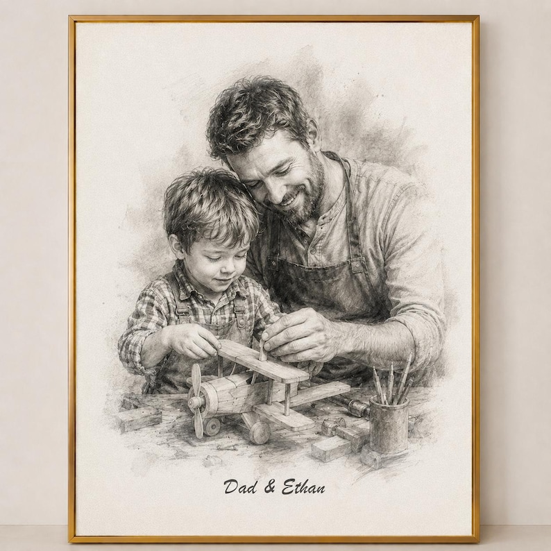 May include: A framed pencil sketch depicts a father and son building a wooden airplane. The image is in grayscale, with the text "Dad & Ethan" at the bottom. The frame is gold.