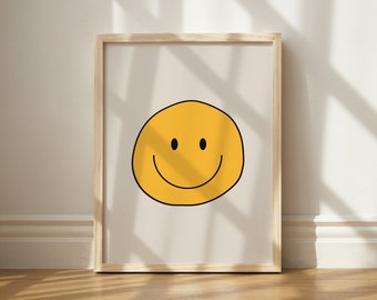 May include: A framed print with a yellow smiley face on a white background. The frame is made of light wood.