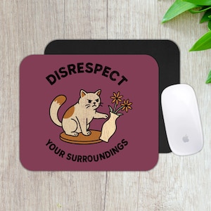 May include: A burgundy mousepad with the words "DISRESPECT YOUR SURROUNDINGS" and a cartoon cat knocking over a vase of flowers. A black mousepad and a white computer mouse are also visible.