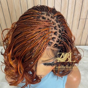 May include: A braided wig featuring a mix of dark brown and copper-orange hair strands. The style includes small, intricate box braids at the scalp transitioning into loose, wavy curls. The text ZBL ZionBellaLuxe Where Luxury meets every strand is visible.