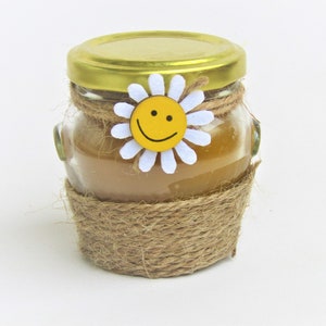 A small sun candle made of natural beeswax in a jar Handmade Natural Beeswax Home decoration An original gift Container candles