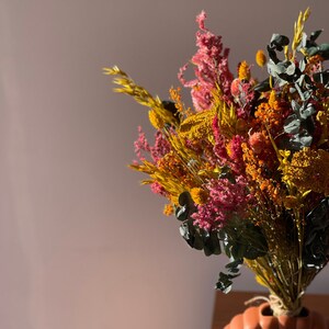 Colorful country bouquet, boho floral arrangement in dried and stabilized flowers handmade by hand. Home decoration or gift.