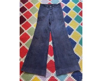May include: A pair of dark blue wide-leg pants with a straight waistband and a button closure.
