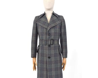 May include: A gray plaid coat with a belt and a notched collar. The coat has a button closure and pockets. The coat is displayed on a mannequin. The plaid pattern includes blue and brown lines.