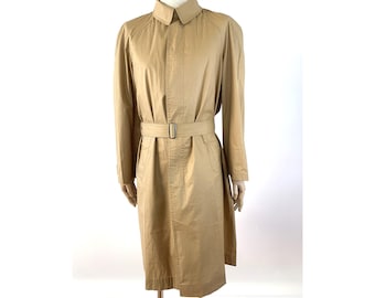 May include: A tan trench coat with a belt. The coat has a classic design with a collar and long sleeves.