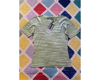 May include: A green and white striped short-sleeved shirt with a round neckline. The shirt has a tag that says "SPORT MISSONI" on it.
