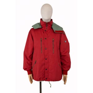 May include: A set of three ceramic mugs with a speckled, matte finish. The mugs are in shades of cream, light gray, and dark gray. Each mug has a simple, minimalist design and a rounded handle.