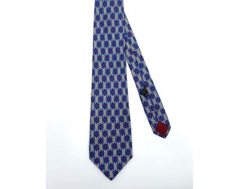 May include: A blue silk tie with a geometric pattern in shades of blue, white, and gold.